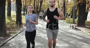 体育夫妇在公园里一起跑步。 年轻人在户外<strong>健身训练</strong>时一起慢跑。 男子和妇女体育